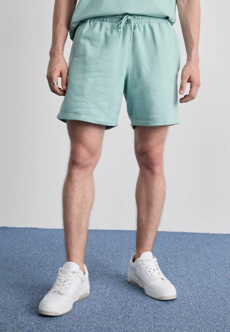 reliable quality adidas Originals PREMIUM ESSENTIALS - Tracksuit bottoms hazy green Streetwear Sale Streetwear Clothing Swimwear Casual Shorts