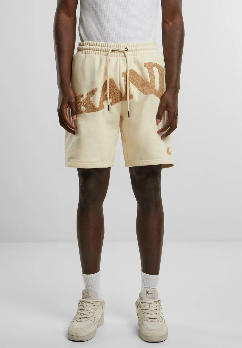 Shop Best Sellers Karl Kani WAVY RETRO - Tracksuit bottoms off white Clothing Shorts Casual Shorts